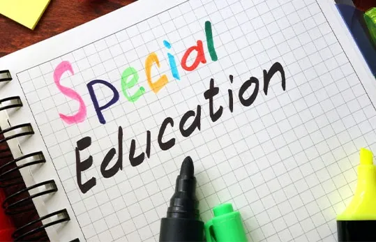 Special education materials being reviewed on a classroom table